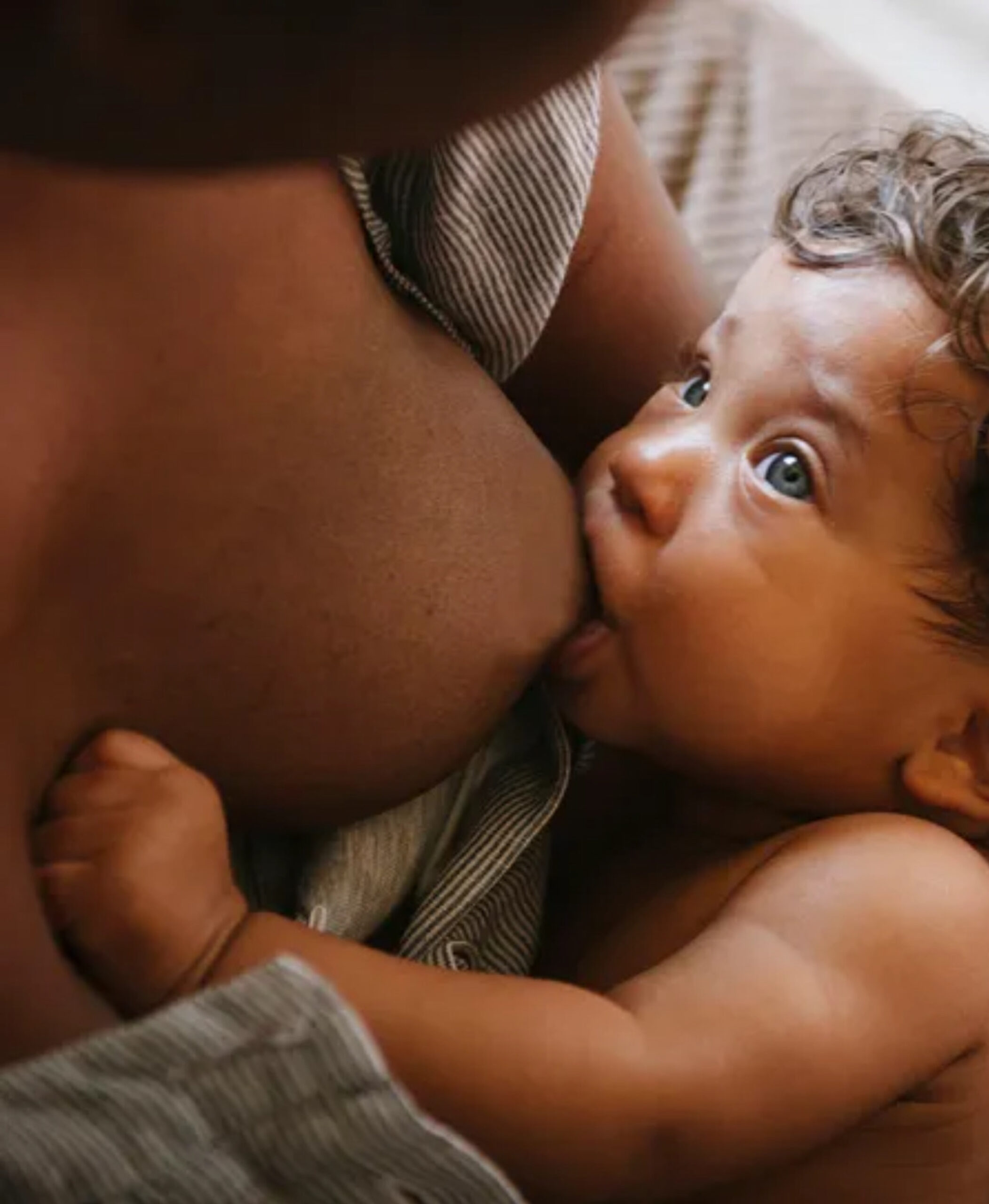 A close-up of a baby nursing