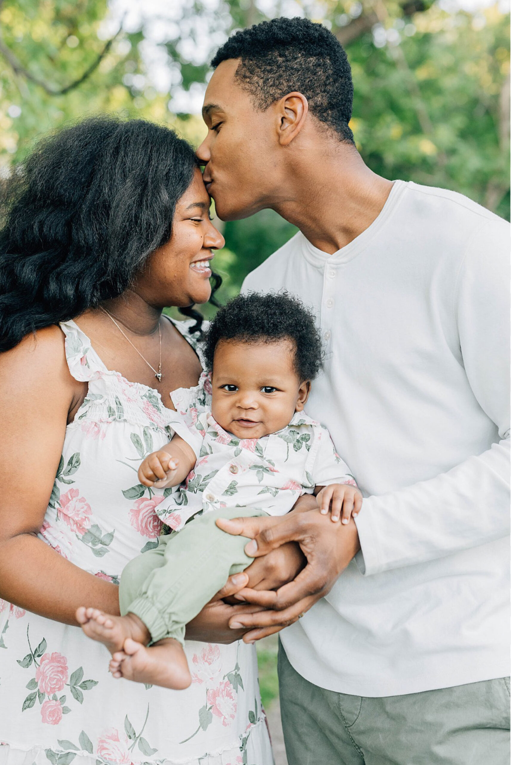 A joyful family portrait featuring a smiling mother and father