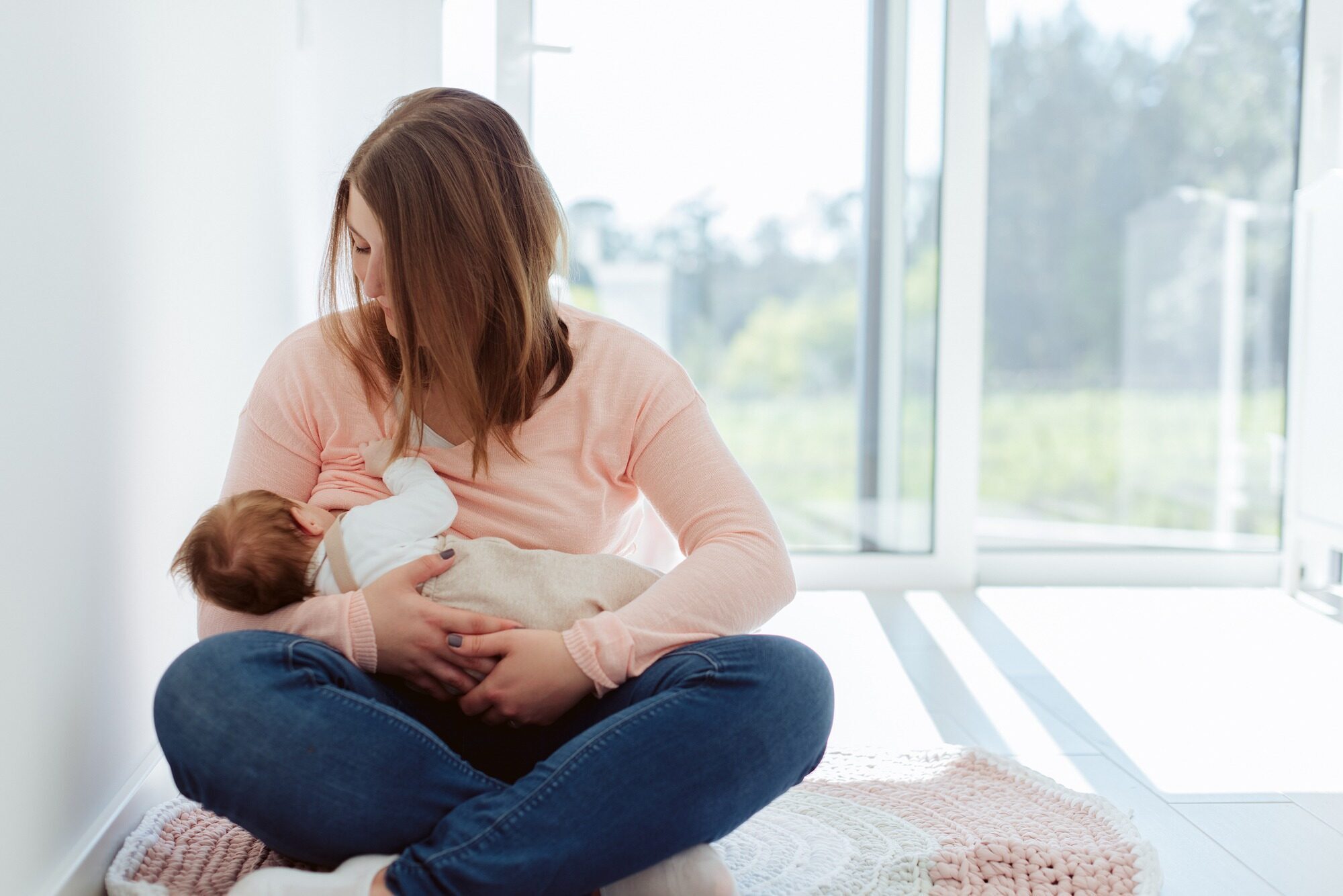 Young Mother breastfeeding newborn baby