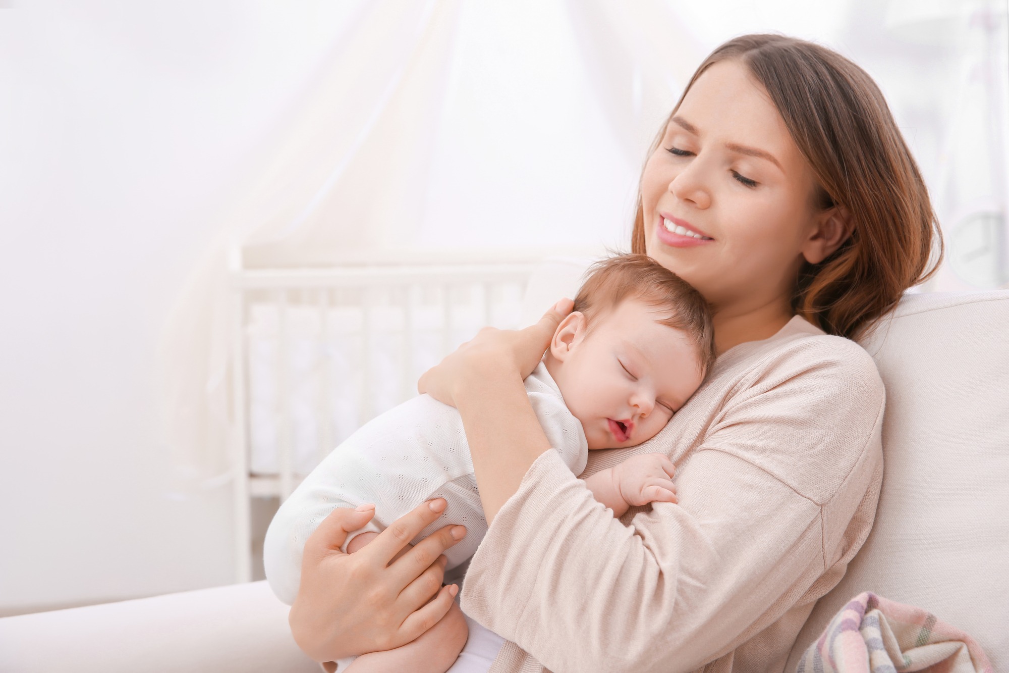 Mother cradles her sleeping baby